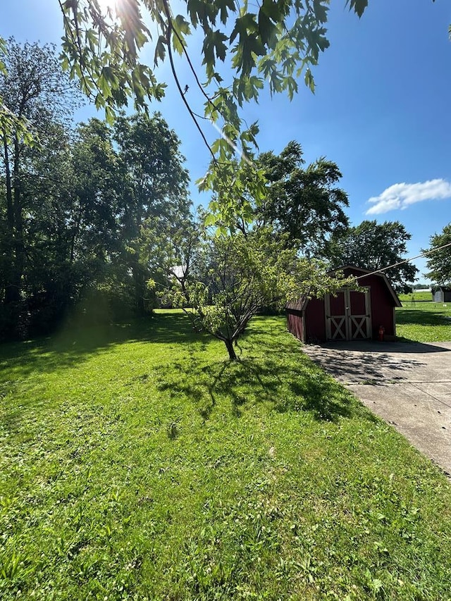 1221 N Sandusky Ave, Bucyrus, OH 44820 - view of green lawn featuring a barn and an outdoor structure