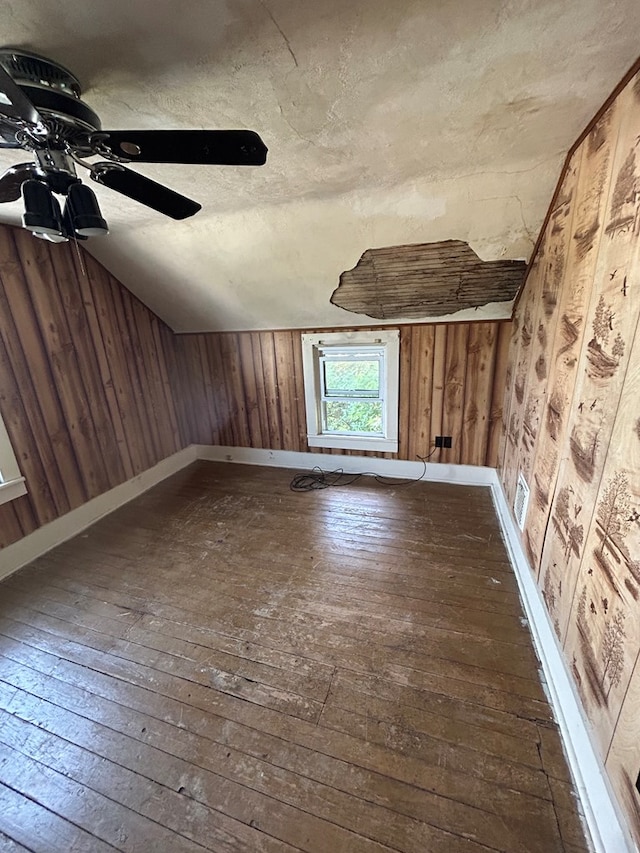 1221 N Sandusky Ave, Bucyrus, OH 44820 - bonus room with dark wood-type flooring, wood walls, and a ceiling fan