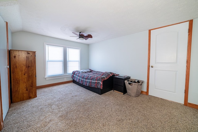 carpeted bedroom featuring ceiling fan, a textured ceiling, and lofted ceiling