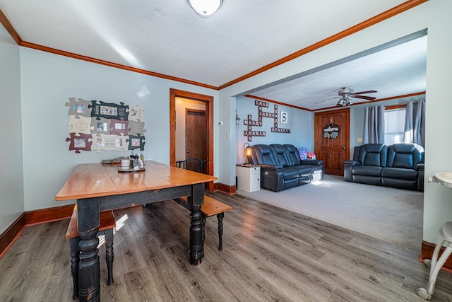 dining room featuring a textured ceiling, ceiling fan, ornamental molding, and wood-type flooring