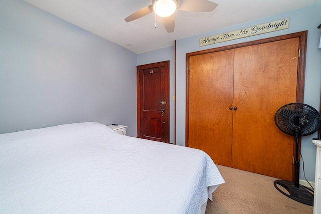 bedroom with ceiling fan, a closet, and carpet floors