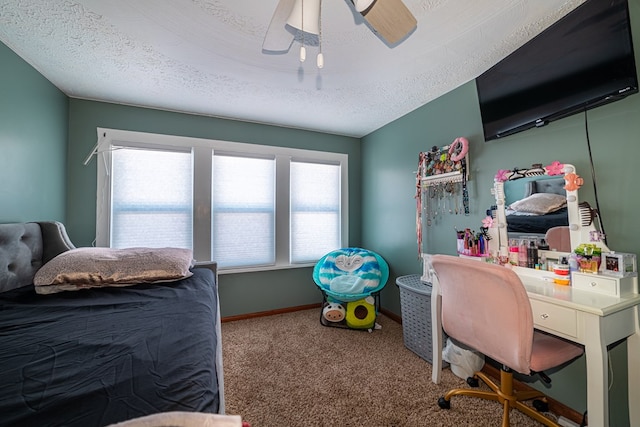 carpeted bedroom featuring ceiling fan, multiple windows, and a textured ceiling