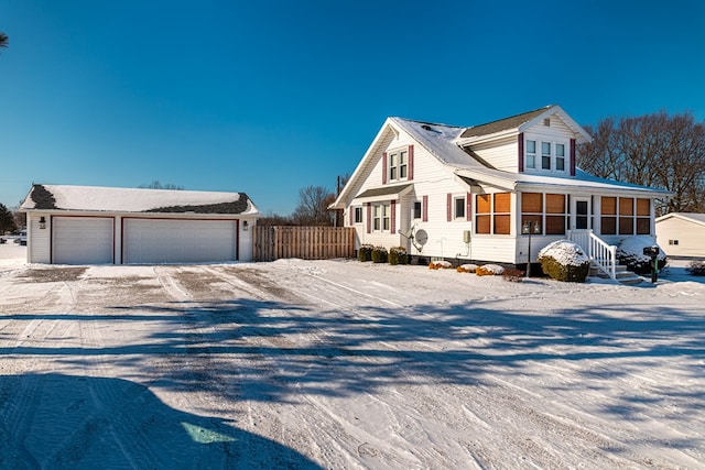 view of front facade with a garage and a sunroom