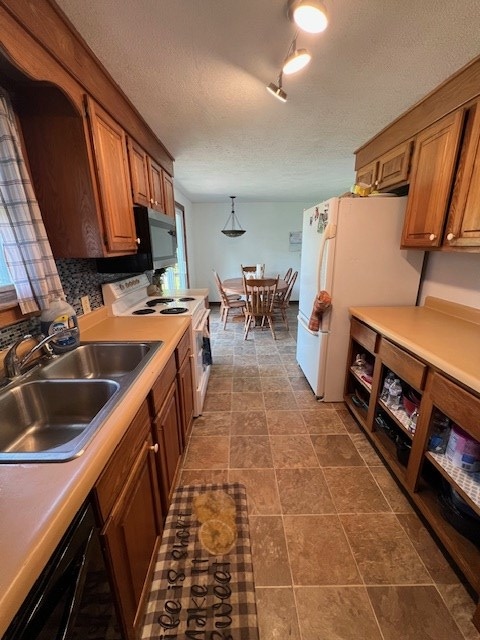 2415 State Route 96, Ashland, OH 44805 - kitchen featuring white appliances, brown cabinets, light countertops, and a textured ceiling
