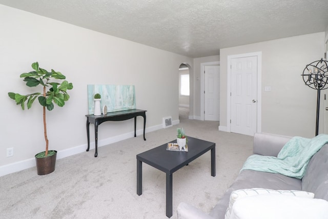 1008 Burger Ave, Mansfield, OH 44906 - carpeted living room with arched walkways, a textured ceiling, and baseboards