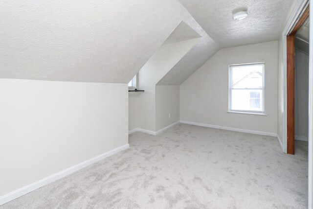 1008 Burger Ave, Mansfield, OH 44906 - additional living space with a textured ceiling, carpet floors, vaulted ceiling, and baseboards