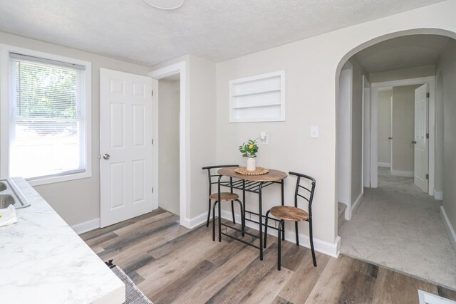 1008 Burger Ave, Mansfield, OH 44906 - dining room with arched walkways, wood finished floors, baseboards, and a textured ceiling