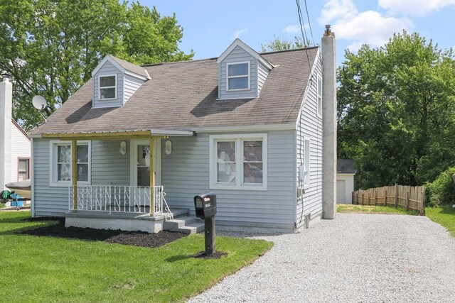 1008 Burger Ave, Mansfield, OH 44906 - view of front facade featuring a porch, a chimney, gravel driveway, and a shingled roof