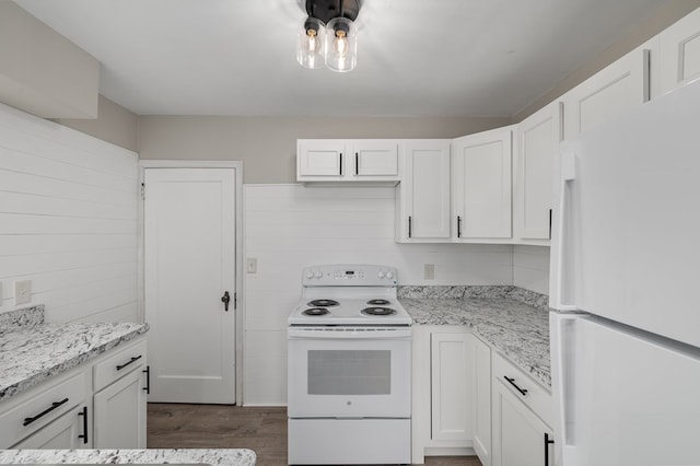 kitchen with white cabinets, white appliances, dark wood-type flooring, and light stone countertops