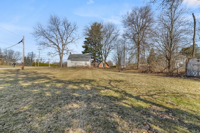 view of yard with an outbuilding and a storage shed
