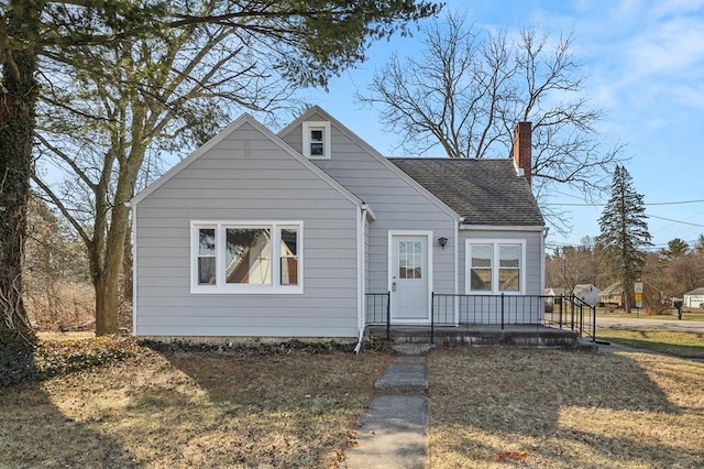 bungalow with a chimney and a shingled roof