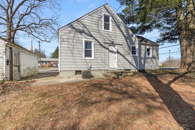 rear view of house with central AC