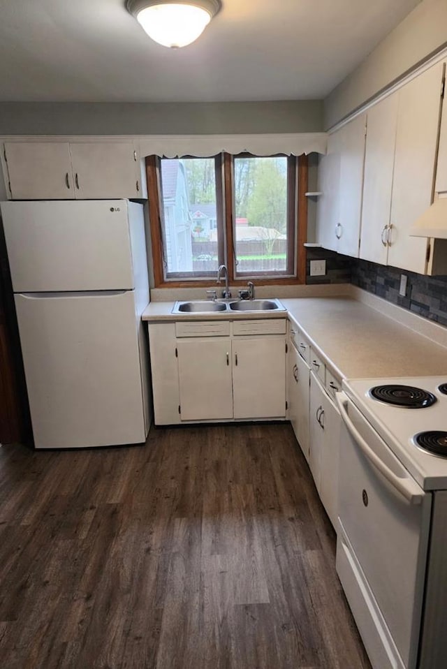 kitchen featuring backsplash, dark hardwood / wood-style floors, sink, white appliances, and white cabinets