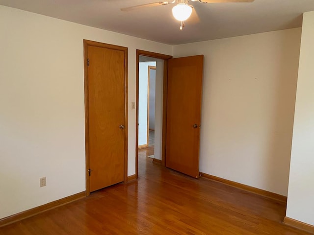 empty room with ceiling fan and wood-type flooring