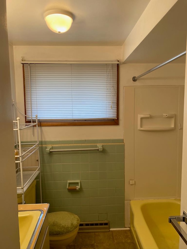 bathroom featuring tile walls, toilet, vanity, and tile patterned flooring