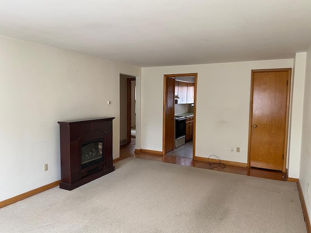 unfurnished living room featuring light colored carpet