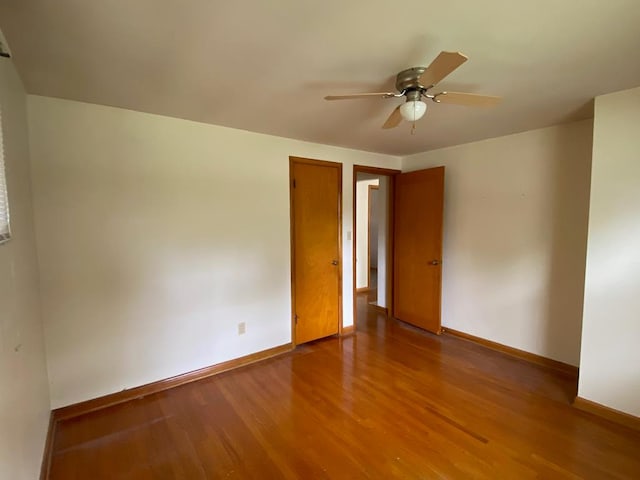 empty room with ceiling fan and hardwood / wood-style floors