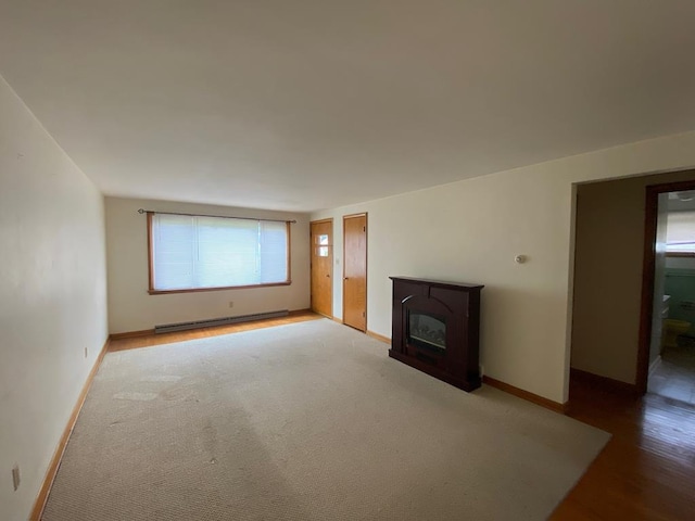 unfurnished living room with baseboard heating