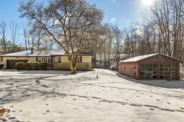 view of snow covered exterior with a garage