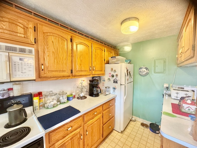 kitchen with light countertops, white appliances, a textured ceiling, decorative backsplash, and brown cabinetry