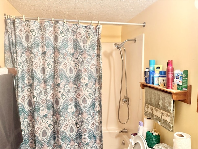 full bathroom with shower / bath combination with curtain, toilet, and a textured ceiling