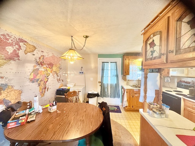 dining area featuring light floors and a textured ceiling