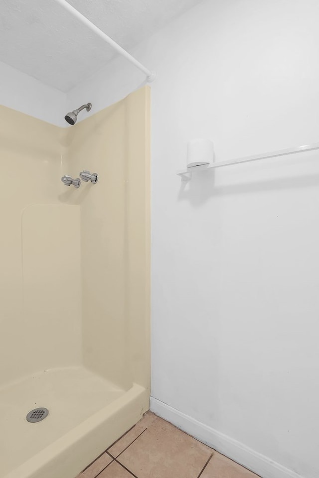 bathroom featuring a shower stall and tile patterned floors
