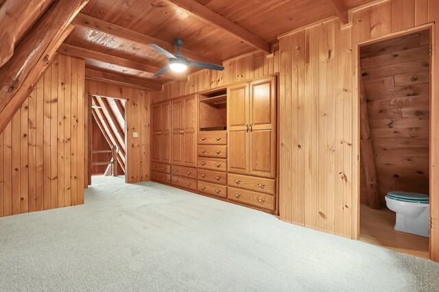 interior space featuring wooden walls, carpet floors, and beamed ceiling