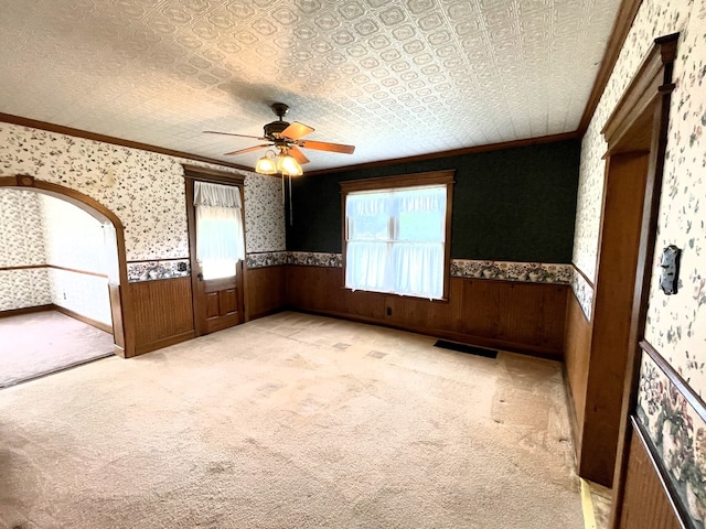 5655 Lime Rd, Galion, OH 44833 - unfurnished room with a wainscoted wall, ornamental molding, light carpet, wallpapered walls, and ceiling fan