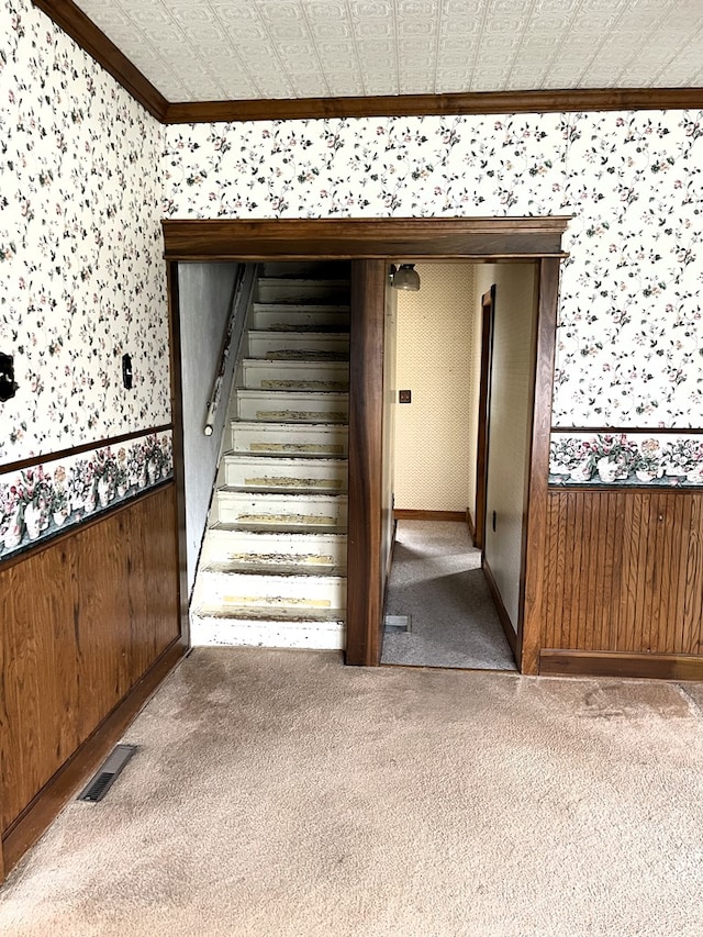 5655 Lime Rd, Galion, OH 44833 - staircase featuring wallpapered walls, ornamental molding, carpet, a wainscoted wall, and wood walls
