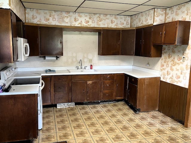 5655 Lime Rd, Galion, OH 44833 - kitchen featuring wallpapered walls, white appliances, light floors, light countertops, and a wainscoted wall