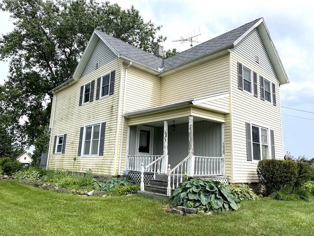 5655 Lime Rd, Galion, OH 44833 - view of front facade with a porch, a chimney, and a front lawn