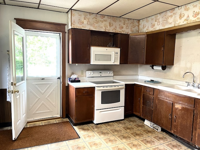 5655 Lime Rd, Galion, OH 44833 - kitchen with white appliances, light countertops, dark brown cabinetry, and wallpapered walls