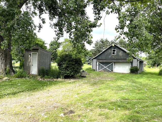 5655 Lime Rd, Galion, OH 44833 - view of green lawn featuring an outdoor structure and a garage