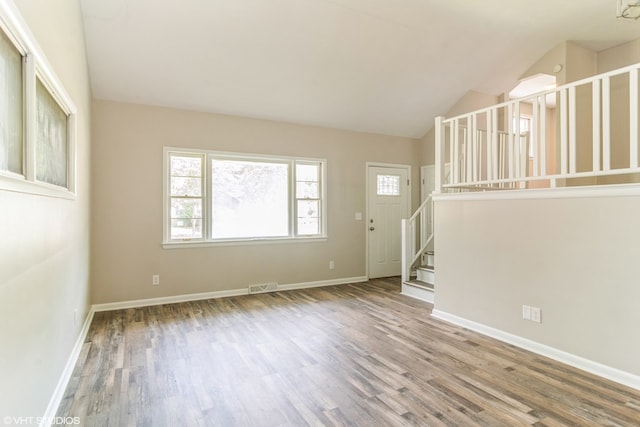 interior space with wood-type flooring and vaulted ceiling