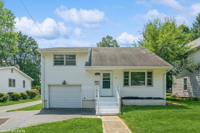 tri-level home featuring a garage and a front yard