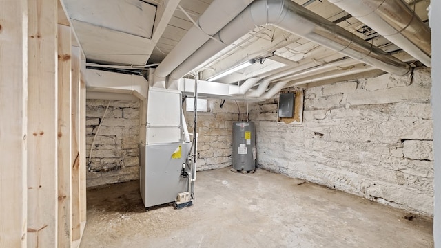 basement featuring electric panel, water heater, and heating unit