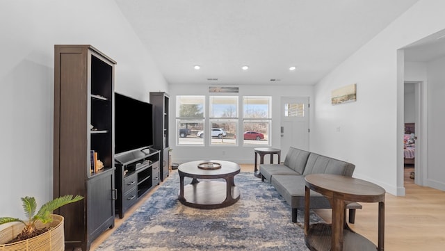 living area featuring baseboards, recessed lighting, and light wood-style floors