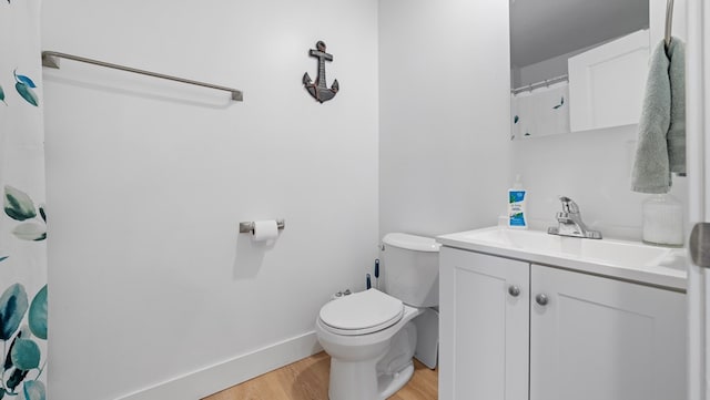 full bathroom featuring baseboards, vanity, toilet, and wood finished floors