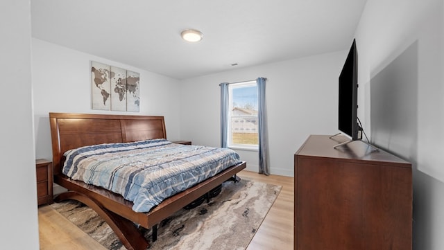 bedroom featuring visible vents and light wood-style flooring