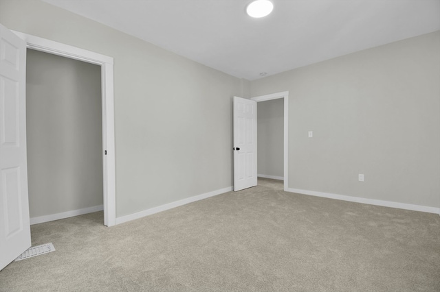 unfurnished bedroom featuring light carpet