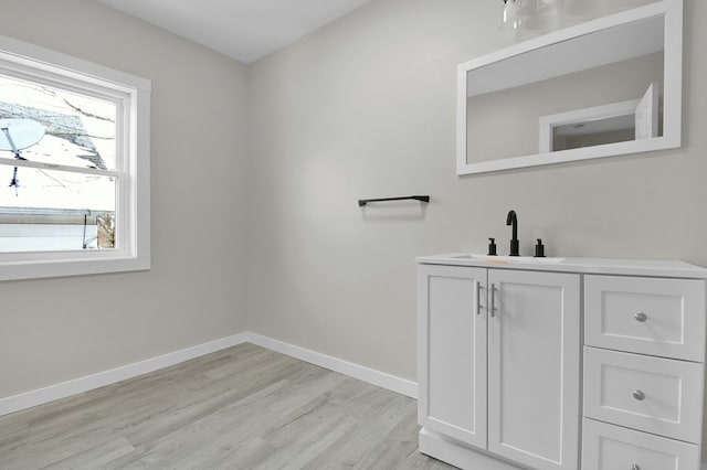 bathroom with hardwood / wood-style flooring and vanity