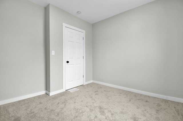 spare room with light colored carpet