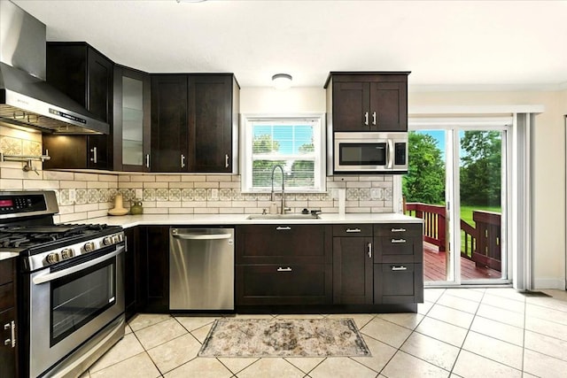 1645 Spring Village Ln, Mansfield, OH 44906 - kitchen with appliances with stainless steel finishes, wall chimney exhaust hood, backsplash, and light countertops
