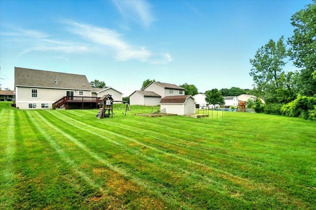 1645 Spring Village Ln, Mansfield, OH 44906 - view of green lawn featuring a deck, stairs, and a storage unit