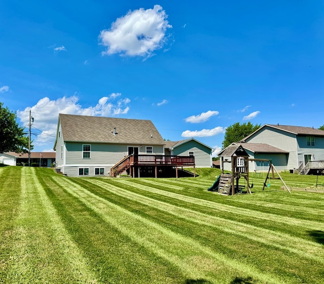 1645 Spring Village Ln, Mansfield, OH 44906 - rear view of property featuring a playground, a wooden deck, and a lawn
