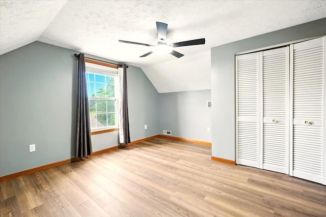 1645 Spring Village Ln, Mansfield, OH 44906 - bonus room with a textured ceiling, light wood finished floors, lofted ceiling, and ceiling fan