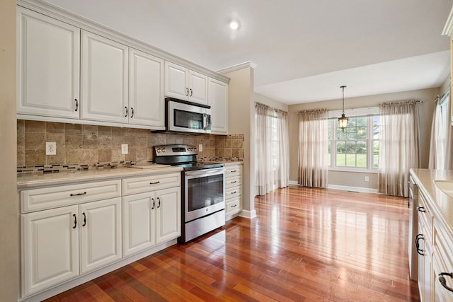 4299 County Road 20, Mount Gilead, OH 43338 - kitchen with stainless steel appliances, light wood-style floors, backsplash, light countertops, and white cabinetry