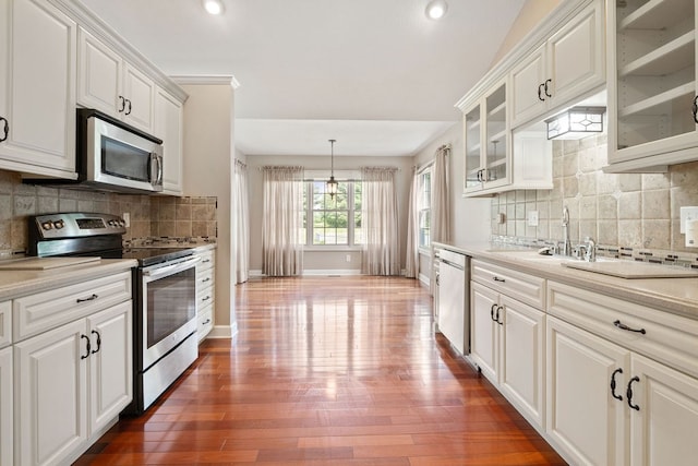 4299 County Road 20, Mount Gilead, OH 43338 - kitchen with stainless steel appliances, light countertops, decorative backsplash, dark wood-style flooring, and glass insert cabinets
