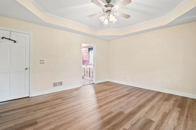 4299 County Road 20, Mount Gilead, OH 43338 - empty room featuring a tray ceiling, light wood-type flooring, ceiling fan, and ornamental molding